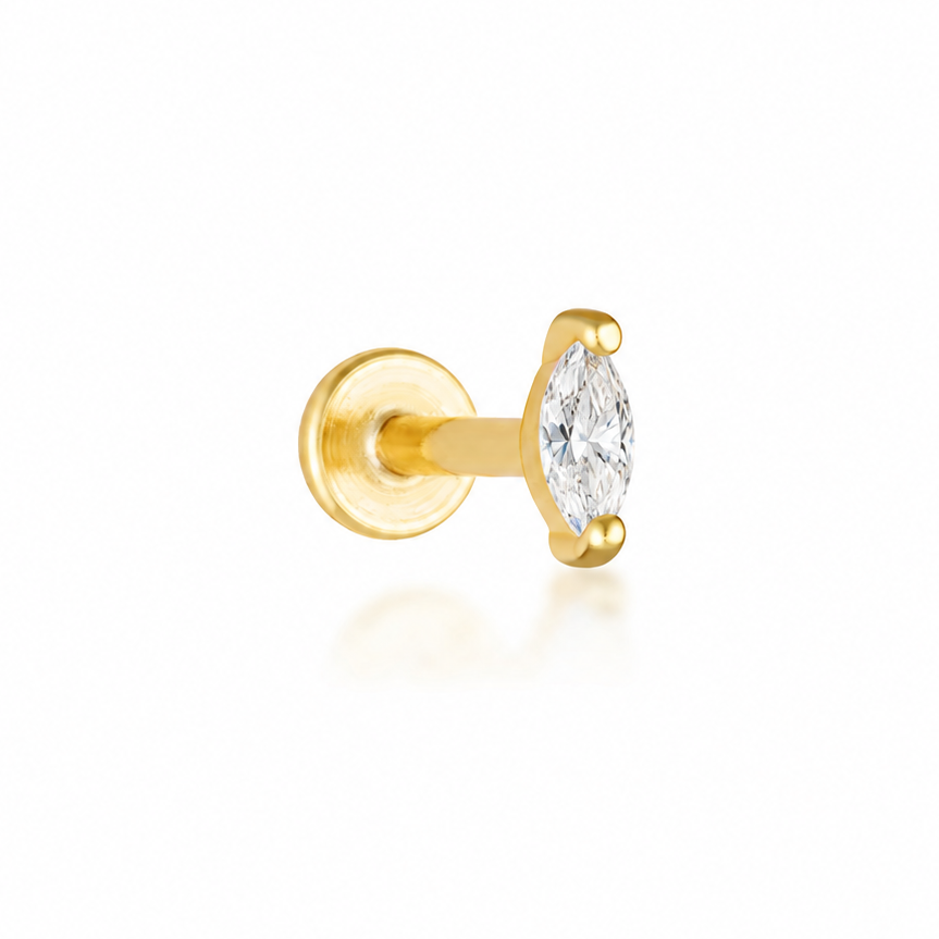 A single gold stud earring featuring a marquise-cut clear gemstone in a prong setting, shown against a clean white background with a soft reflection.
