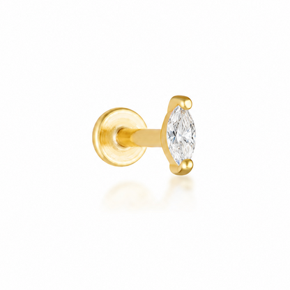 A single gold stud earring featuring a marquise-cut clear gemstone in a prong setting, shown against a clean white background with a soft reflection.