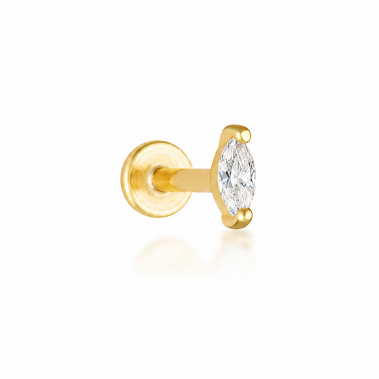 A single gold stud earring featuring a marquise-cut clear gemstone in a prong setting, shown against a clean white background with a soft reflection.